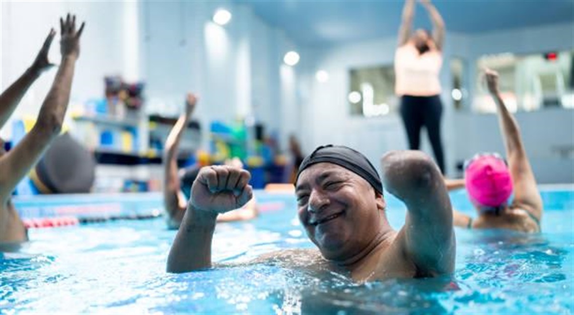 An elderly man in a pool