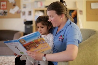 Educator and child reading time