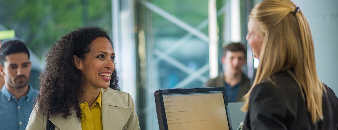 Image of a female customer chatting to a receptionist