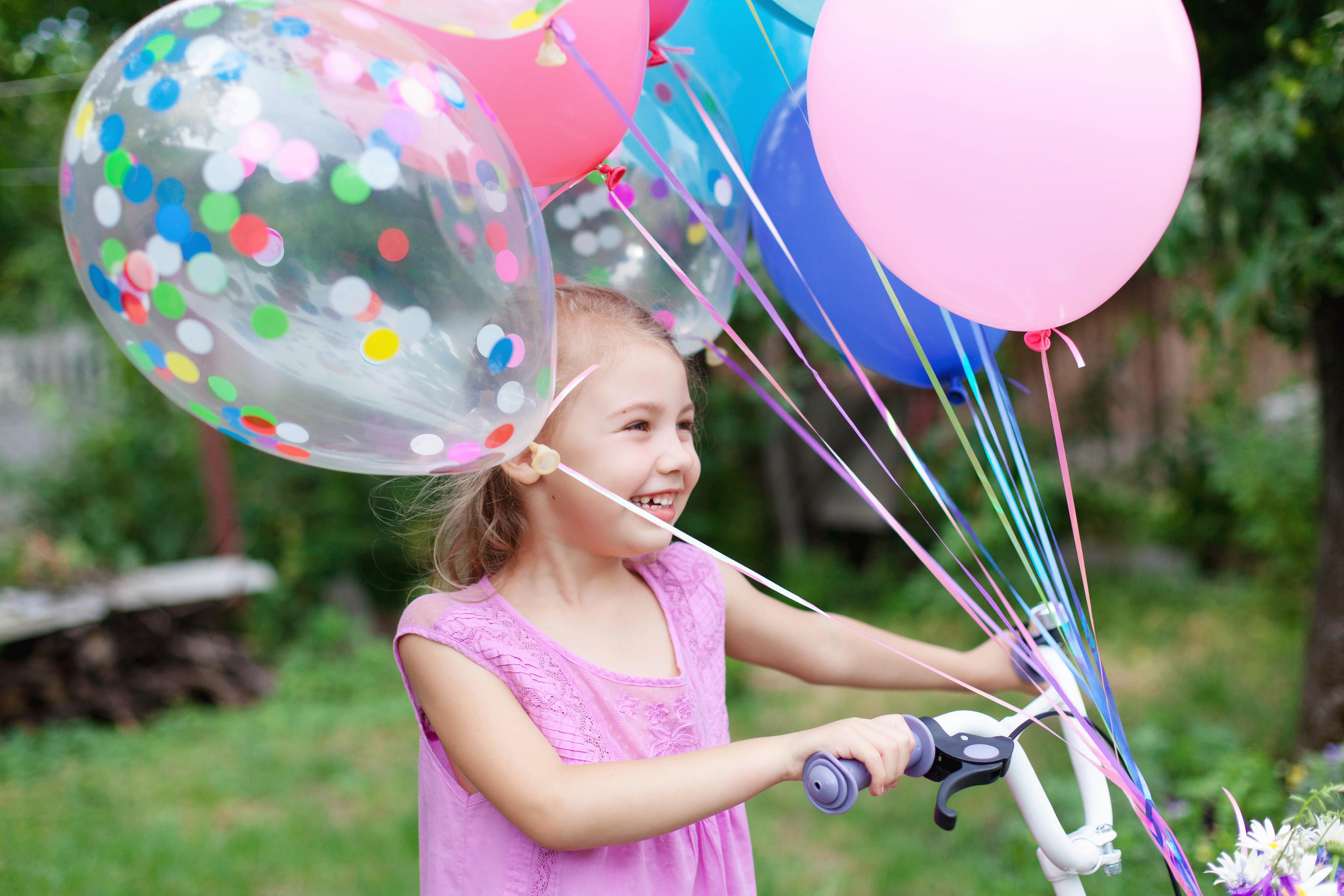 Girl having birthday celebration riding a bike