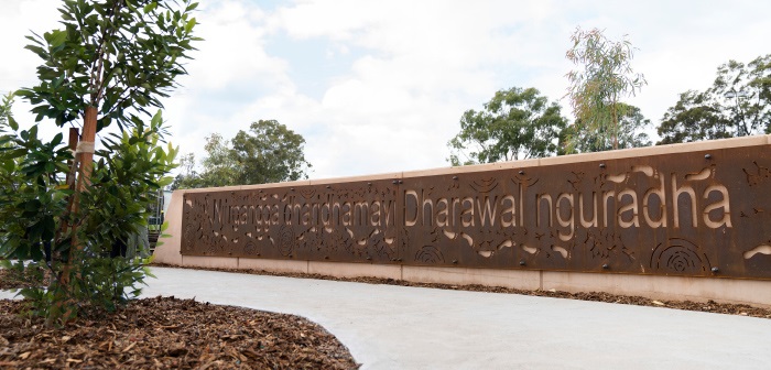 Billabong entry parkway with welcome sign and vegetation