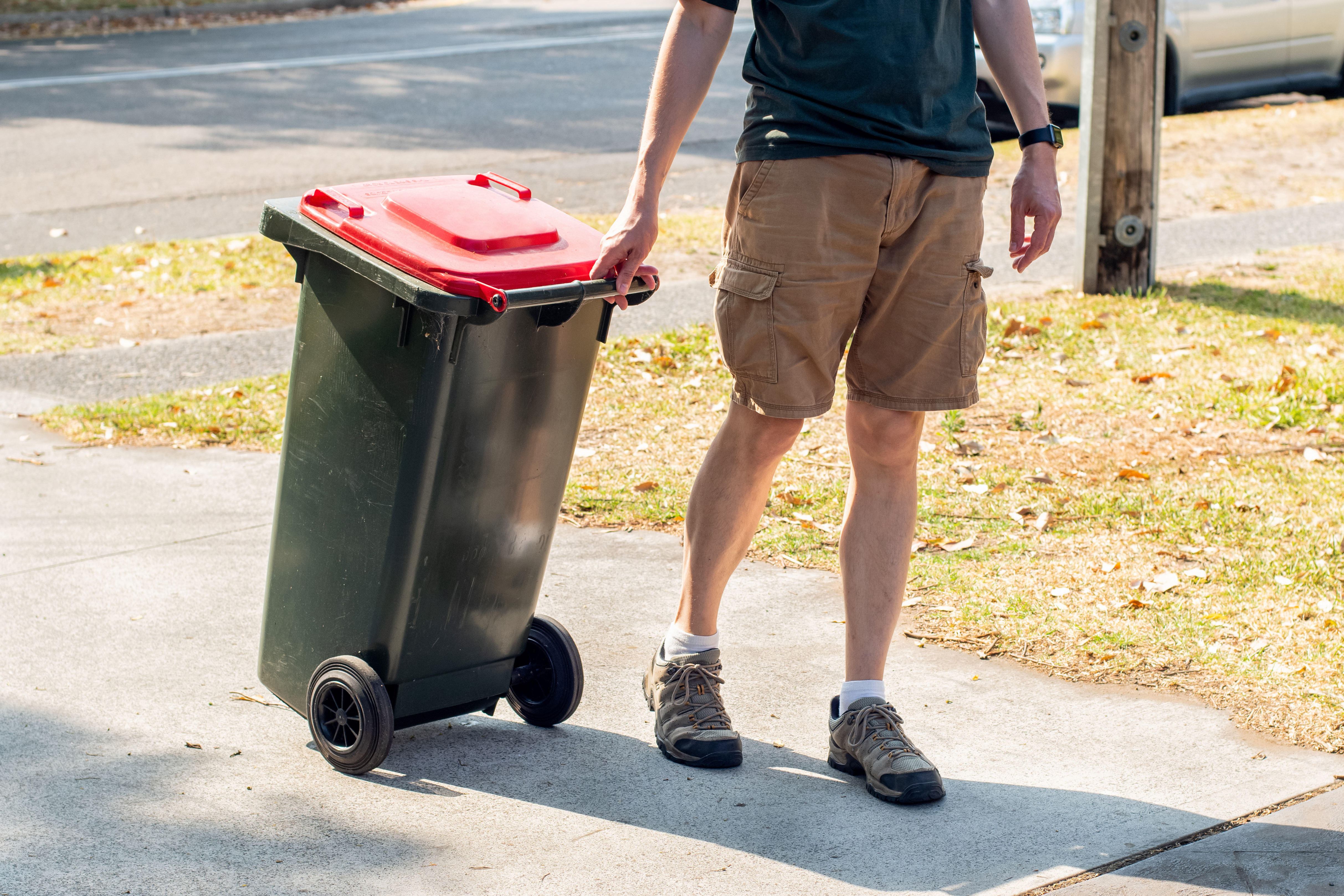 Man walking bin out for collection