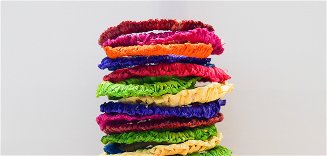 A pile of woven bracelets