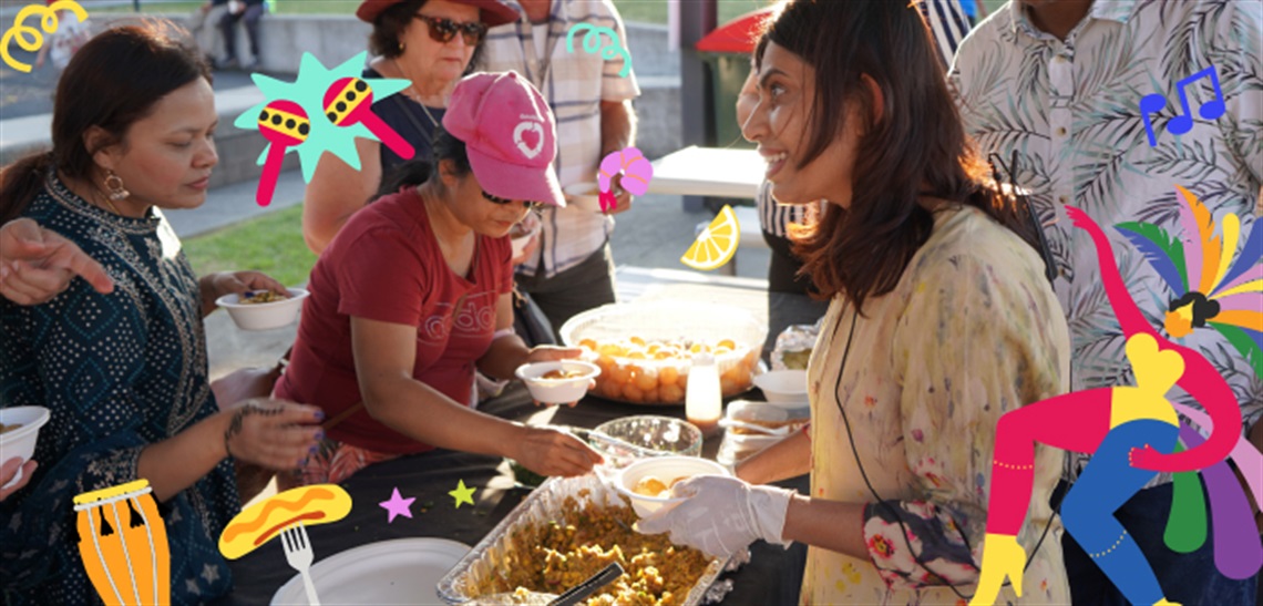 People standing around a table of food