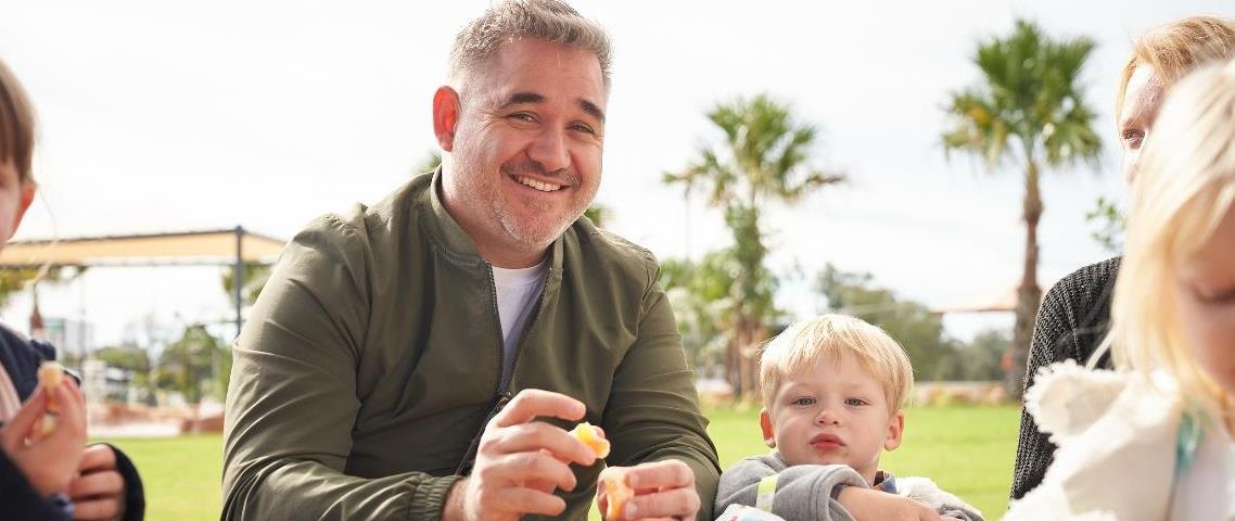 A father and his son sit at a table at the Billabong