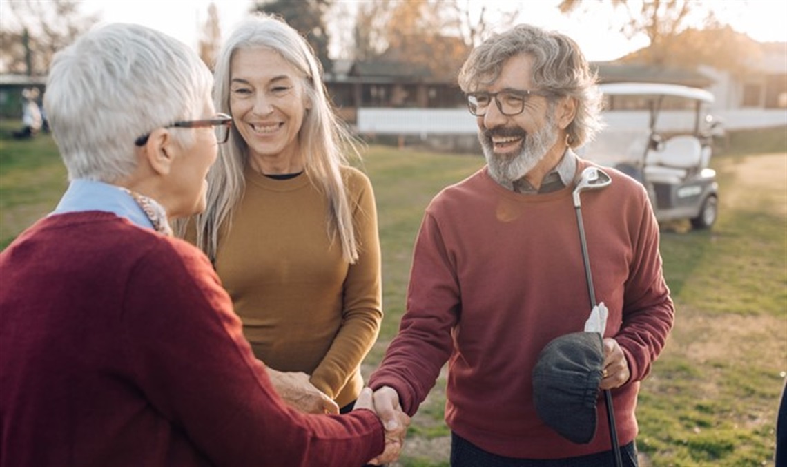 Seniors shaking hands at a golf game